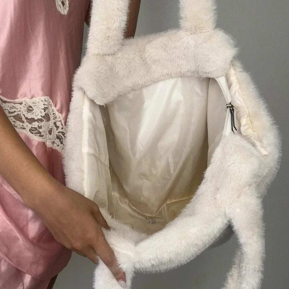 oversized white faux fur tote bag with embroidered logo